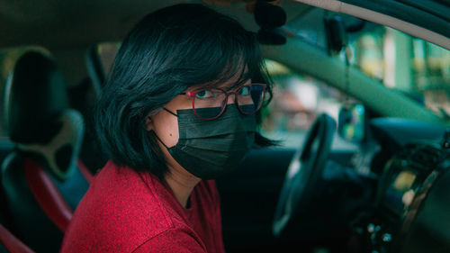 Pretty young miss with glasses in black mask 