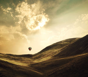 Hot air balloon over mountain landscape