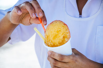 Midsection of man holding ice cream