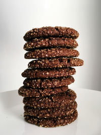 Close-up of stack on table against white background