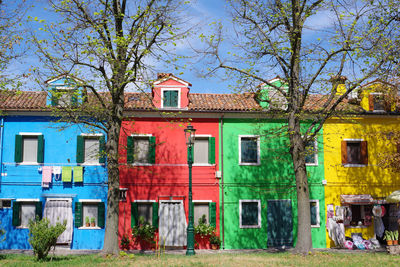 Houses by street against sky in city