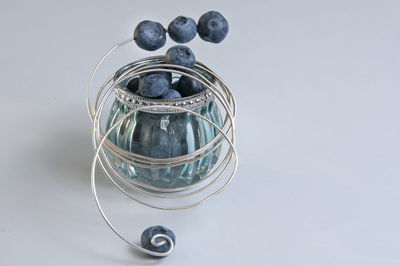 Close-up of glass container on table against white background