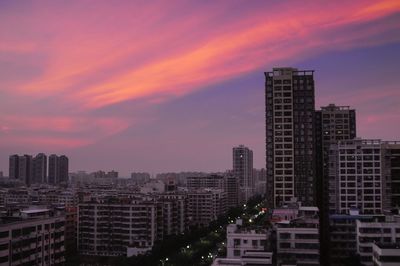 Cityscape against sky at sunset