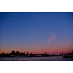Silhouette of city at waterfront