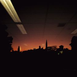 Low angle view of silhouette buildings against sky at sunset