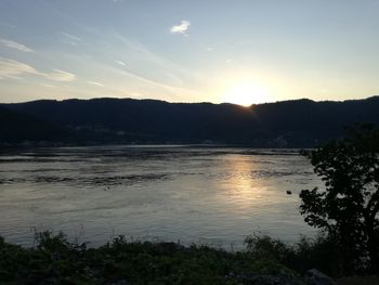 Scenic view of lake and mountains during sunset