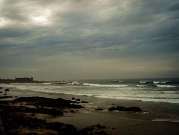 Scenic view of sea against cloudy sky