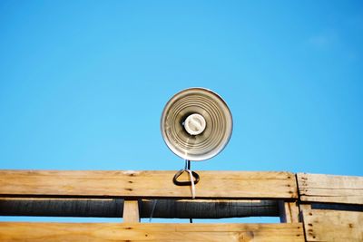 Low angle view of lamp post against clear blue sky