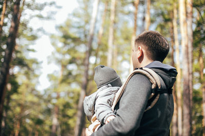 Rear view of couple kissing in forest