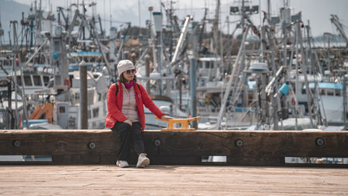Portrait of young man standing at harbor