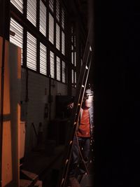 Man standing by ladder in workshop