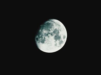 Low angle view of moon against dark sky