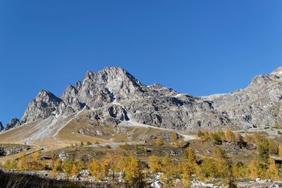 Low angle view of mountains against clear blue sky