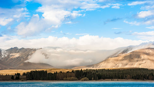 Scenic view of lake and mountains against sky