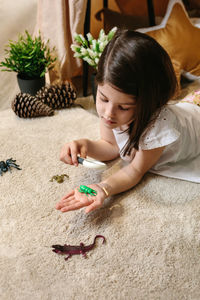 High angle view of girl playing on table at home