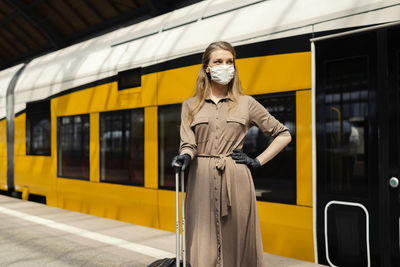 Portrait of man standing on train at railroad station