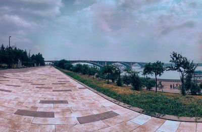 Footpath in park against sky