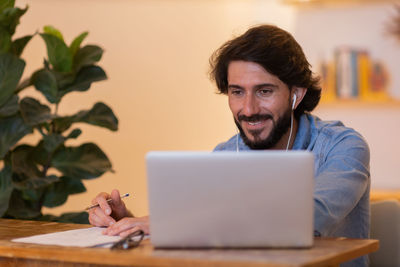 Young business man working with laptop. gray notebook for working. home office . 