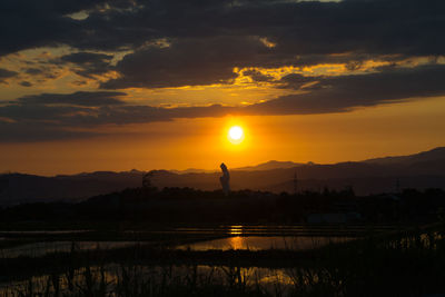 Scenic view of silhouette landscape against sky during sunset