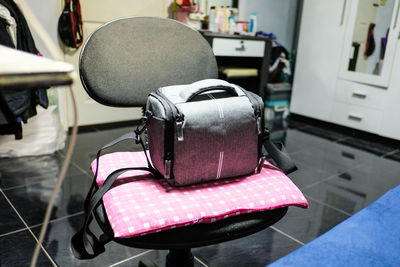 Close-up of bag on chair at barber shop