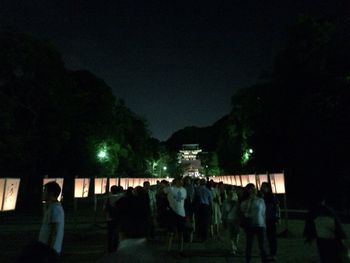 Silhouette people walking at night