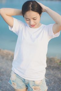 Midsection of woman standing at beach