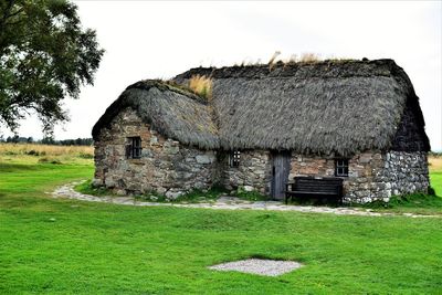 Built structure on field against sky