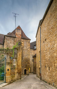 Street amidst buildings against sky