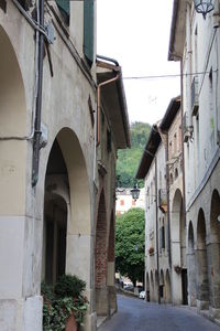 Street amidst buildings in city against clear sky