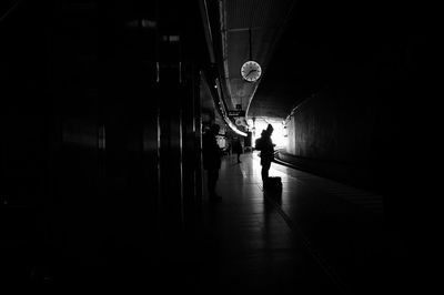 Full length of woman walking in tunnel