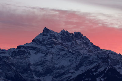 Scenic view of snowcapped mountains against sky during sunset