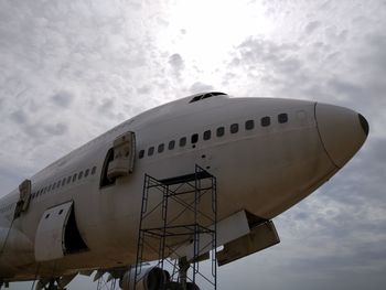 Low angle view of airplane flying against sky