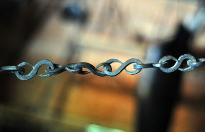 Close-up of water drops on metal chain