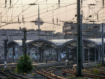 Railroad tracks in city against sky