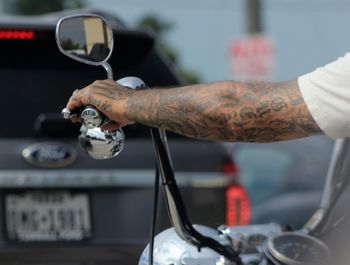 Close-up of man working on motorcycle