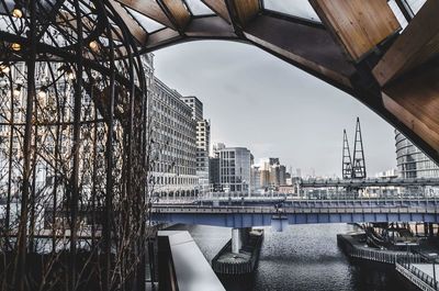 Bridge in city against sky