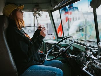 Woman sitting in truck drivers seat