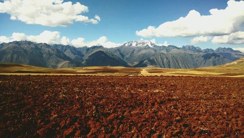 Scenic view of mountains against cloudy sky