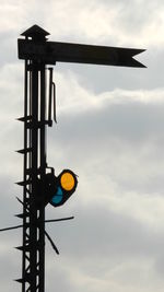 Low angle view of communications tower against sky