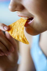 Cropped hand of woman eating food