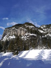 Scenic view of snowcapped mountains against blue sky