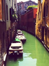 Boats in canal along buildings