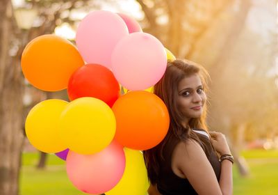 Portrait of young woman with balloons