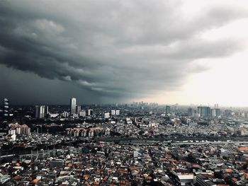 High angle view of city against cloudy sky