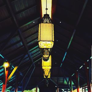 Low angle view of illuminated lights hanging from ceiling