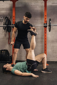 Personal trainer correcting habits in the exercise room. personalized individual training