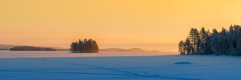 Scenic view of landscape against clear sky during winter