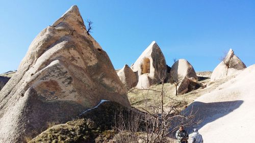 Low angle view of mountain against blue sky