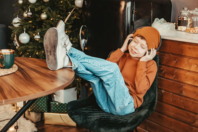 Full length of woman sitting on chair