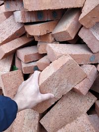 Cropped hand holding brick